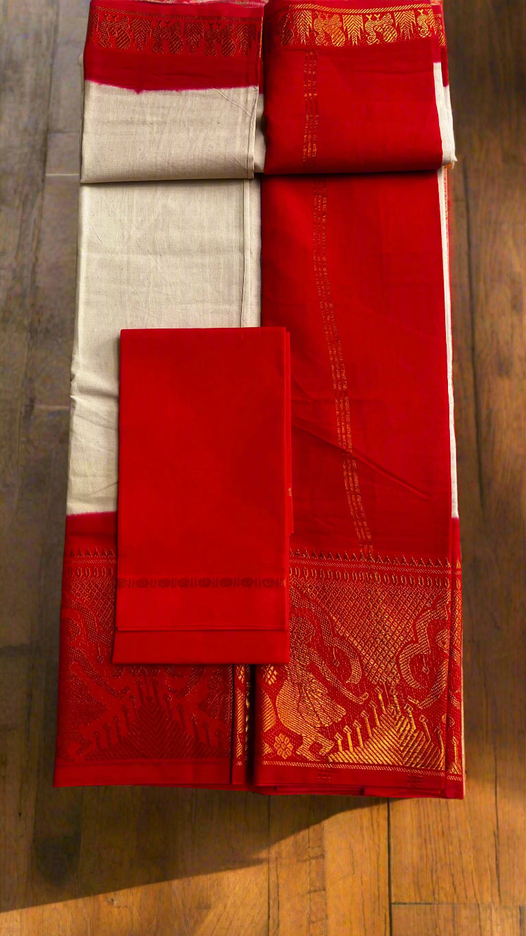 Red and beige saree with gold border on a textured surface