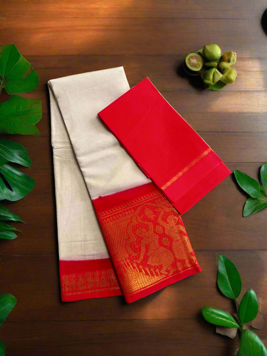 Two sarees, one red and one beige with a red border, on a woven mat.