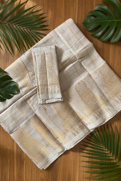 A folded and draped off-white or light beige fabric, likely a saree or textile, featuring intricate golden-brown traditional motifs and a subtle checkered pattern.