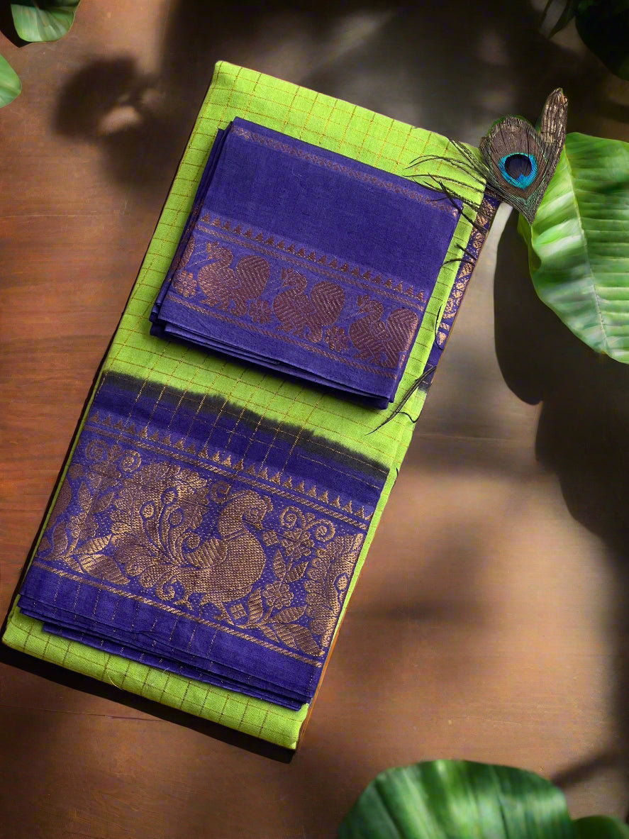 Green and blue traditional fabric with peacock feather on a woven background