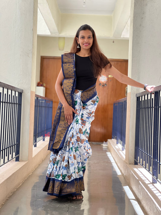 Woman in a traditional saree standing in a hallway