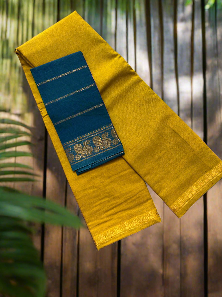 Yellow saree with blue border on a textured surface