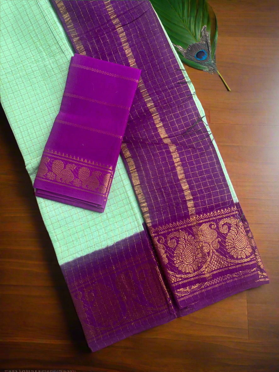 Purple saree with gold patterns on a textured surface