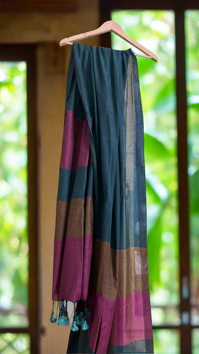 Colorful saree with tassels on a hanger against a home interior background