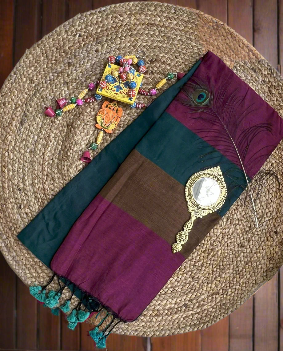 Colorful saree with decorative items on a woven mat
