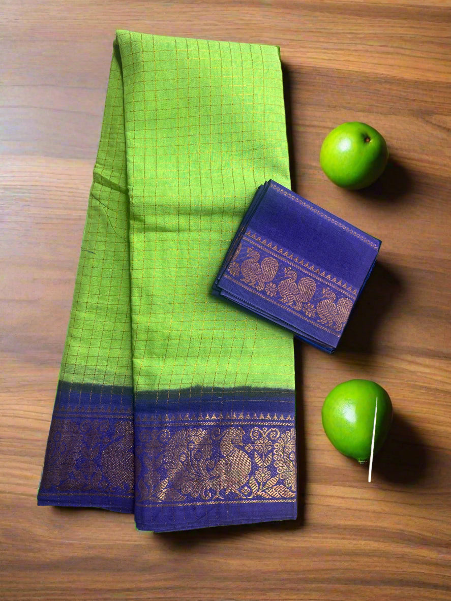 Green saree with blue border and matching pouch on a textured surface