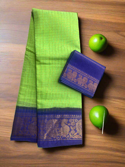 Green saree with blue border and matching pouch on a textured surface