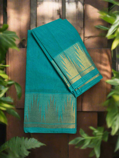 Green saree with gold border on a wooden surface