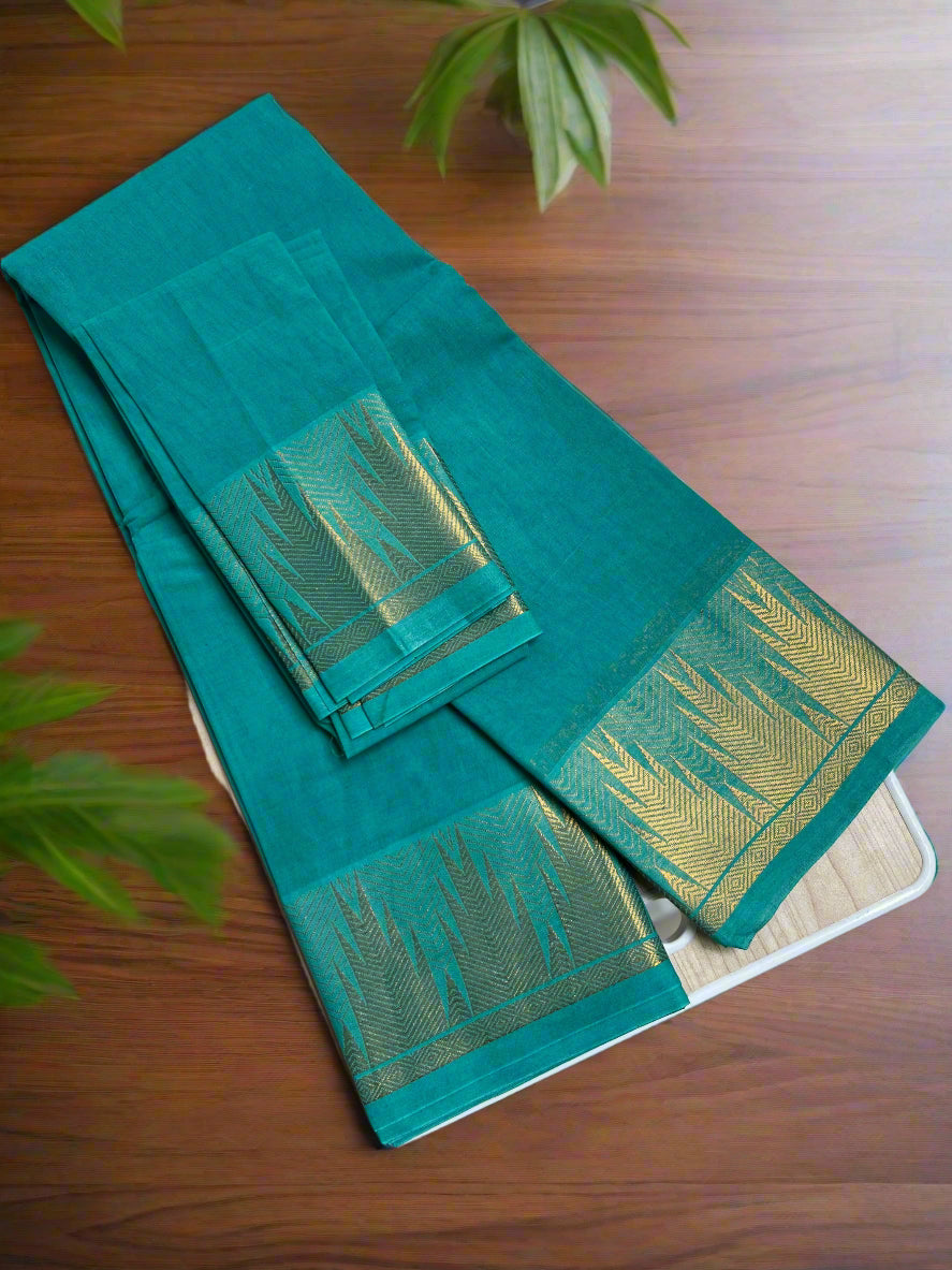 Teal saree with gold border on a white stool