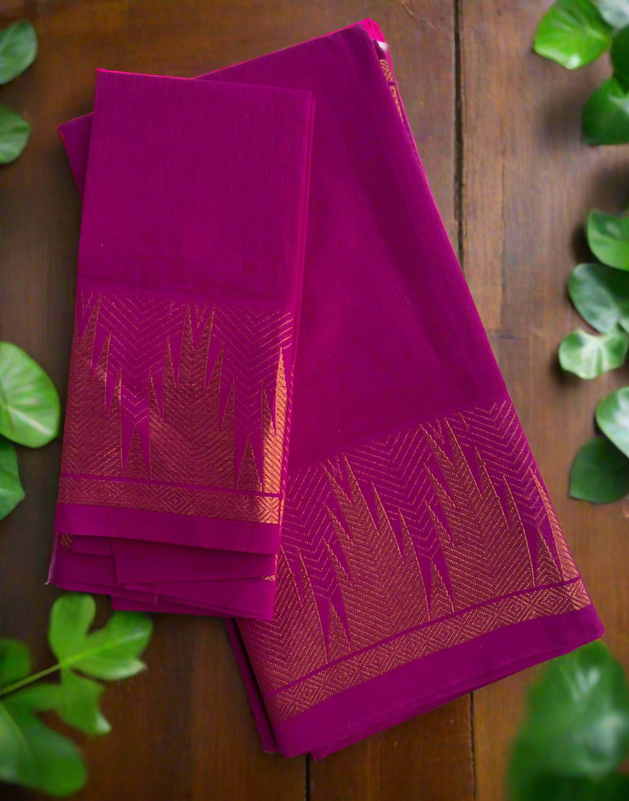 Folded purple fabric with red patterns on a light wooden surface