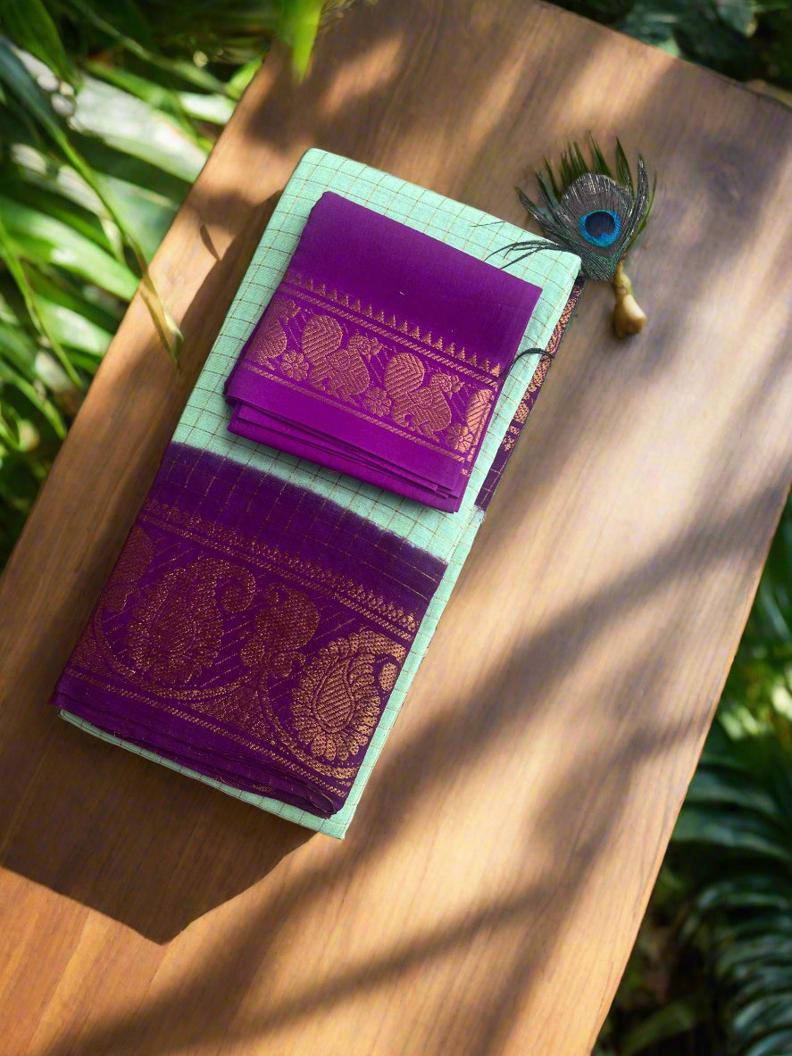 Purple fabric with gold patterns inside a green fabric case on a textured surface