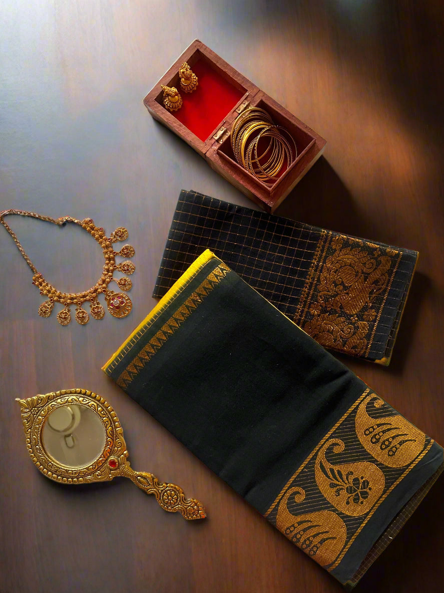Jewelry set including necklace, bangles, and mirror on a white fabric background