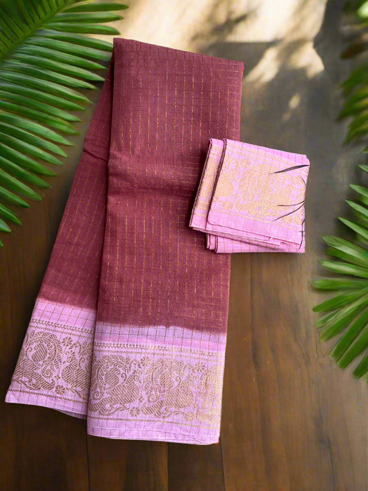 Maroon and pink saree with a peacock feather on a textured surface