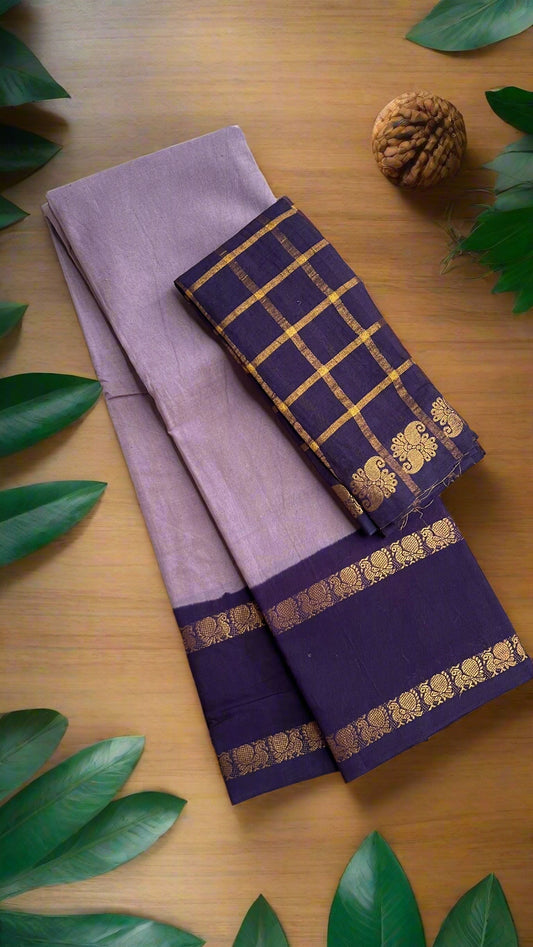 Purple saree with gold border on a woven mat