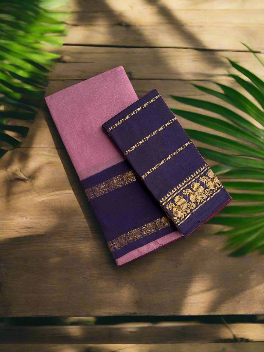 Two folded fabrics, one pink and one purple with gold patterns, on a textured surface.
