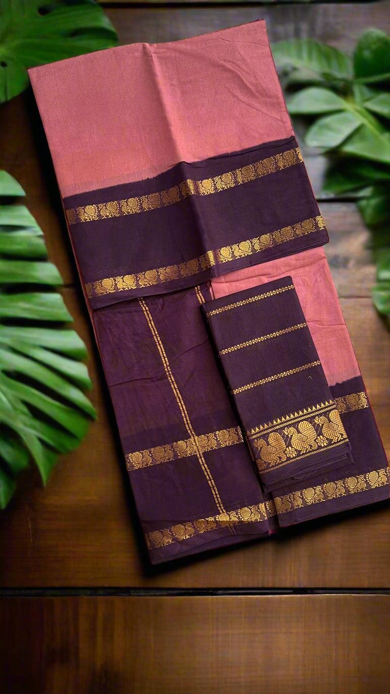 Pink and purple saree with gold border on a woven mat