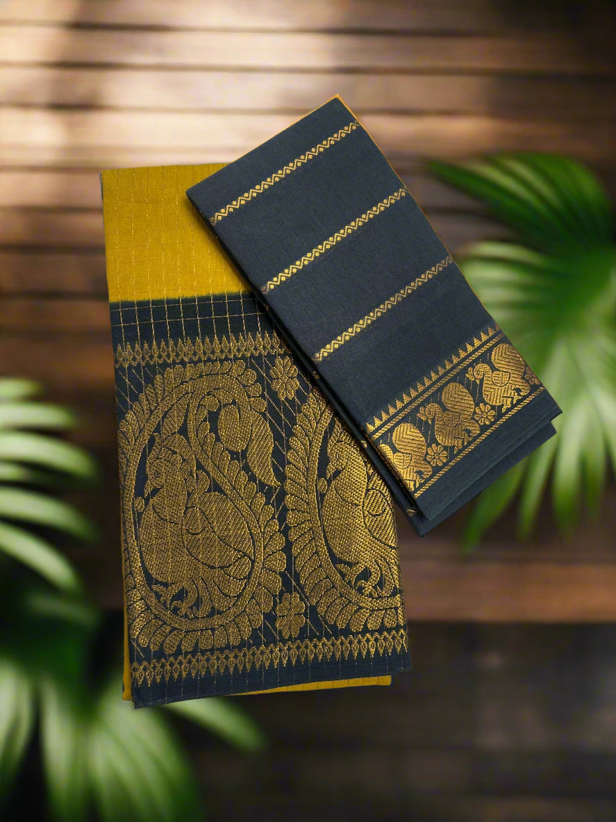 Black and yellow saree with intricate patterns on a wooden surface
