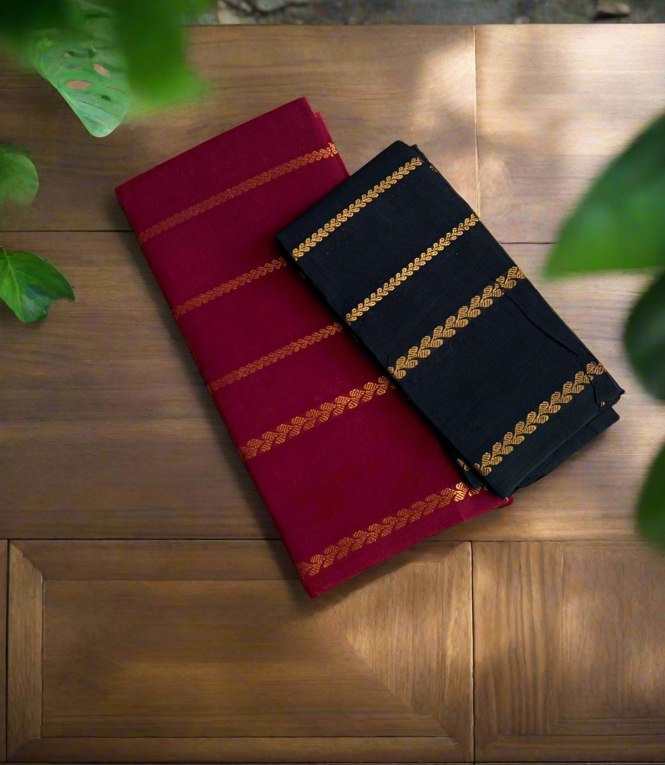Two folded cloths, one red and one navy with gold stripes, on a textured woven surface.